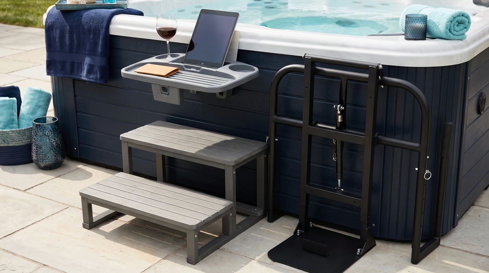 Spa tray table, entry steps and cover lifter beside a spa